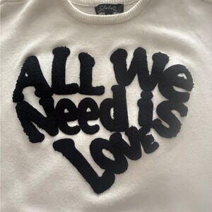 Charlie B All We Need is LOVE. White Sweater with Black Text Design